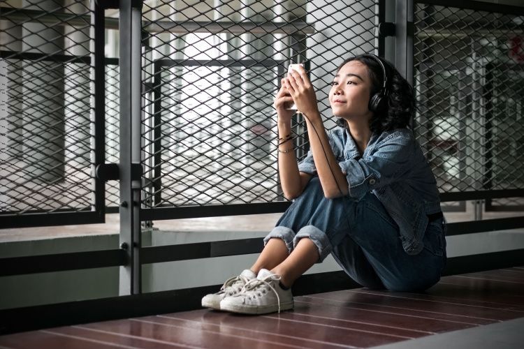 woman sat on floor with mobile phone
