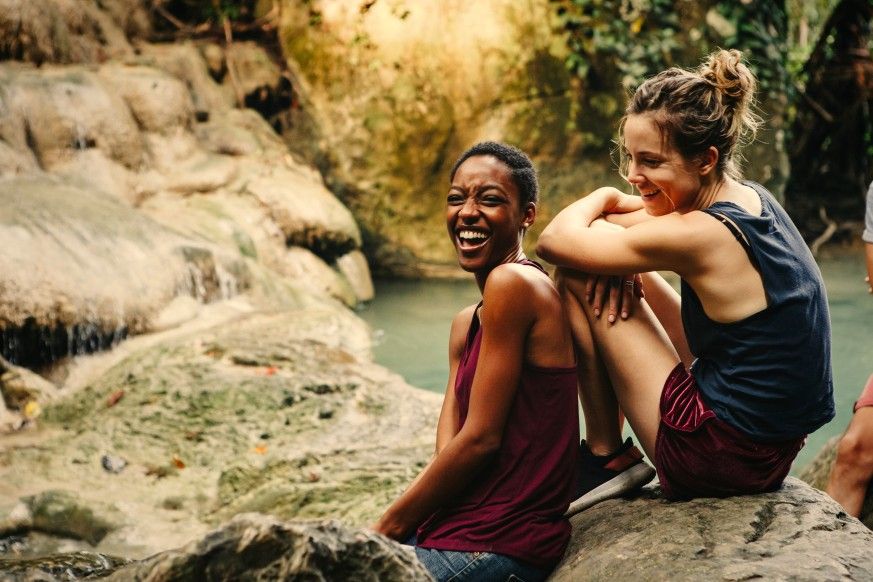 Friends hanging out at a waterfall